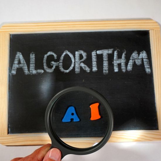 The word algorithm written on a handheld chalkboard